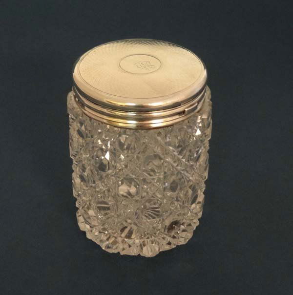 A Victorian cut glass dressing table jar with HM silver: A Victorian cut glass dressing table jar with HM silver lid with leather insert to inside of lid London 1857 maker Thomas Johnson the lid marked under Leuchars Picadilly London 3 1/2" high