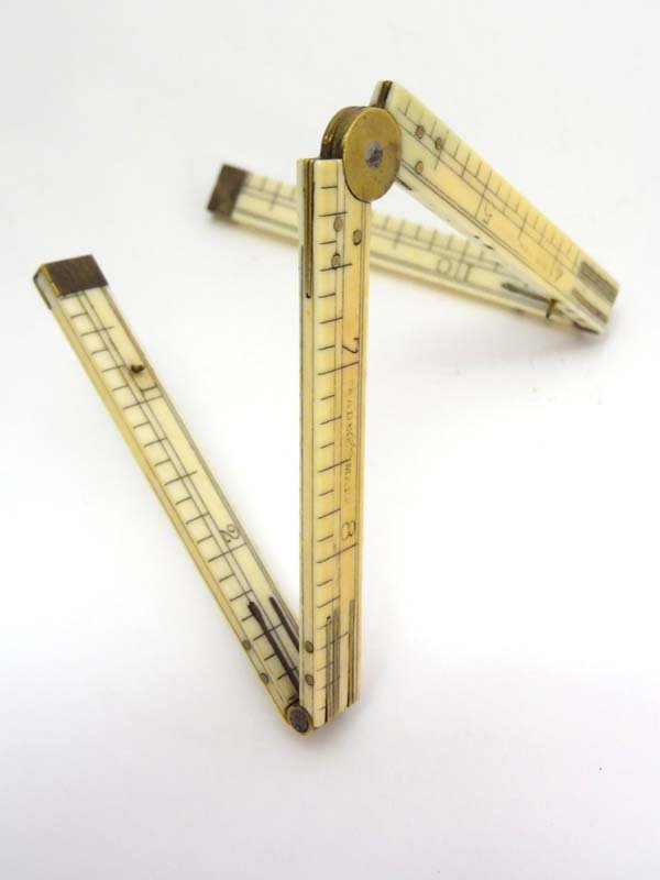 A 19thC 12" ivory and brass folding rule signed (E: A 19thC 12" ivory and brass folding rule signed (E Preston & Sons).