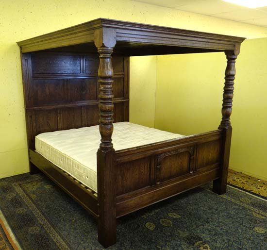 A fine oak panelled Cotswold four poster bed 75 1/2": A fine oak panelled Cotswold four poster bed 75 1/2" wide x 78" high with fitted mattress (super king)