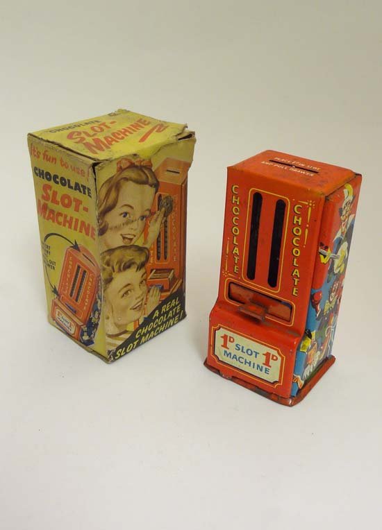 A c1930s tinplate chocolate 1D slot machine, marked: A c1930s tinplate chocolate 1D slot machine, marked G590 Made in England, with original box. Approx 5 3/4" tall.