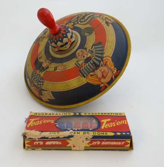 A c1940s German vintage tinplate child's spinning top: A c1940s German vintage tinplate child's spinning top made by MFZ, together with a boxed ' Teas'em ' game, c1950s. (2)