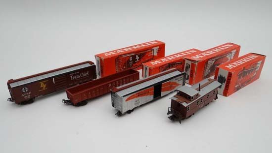 A collection of four red boxed Marklin models,: A collection of four red boxed Marklin models, comprising Gondola American Open Truck 4571, American Covered Truck x 2 4572 and 4575 and Caboose American Brake Van 4570 (4)