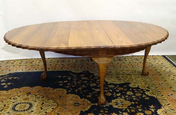 A mid - late 20thC Eastern oval extending dining table: A mid - late 20thC Eastern oval extending dining table with wavy edge and 4 cabriole legs terminating in ball and claw feet 70 1/2" wide x 90 1/2" long (extended) will seat 8-10 £400 - 600