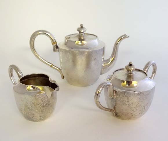 Chinese Export Silver : An early 20thC Chinese Export s: Chinese Export Silver : An early 20thC Chinese Export silver 3 piece tea set comprising teapot milk jug and lidded sugar all with finely fitted decoration, marked under. Maker Luen Hing of of Shanghai