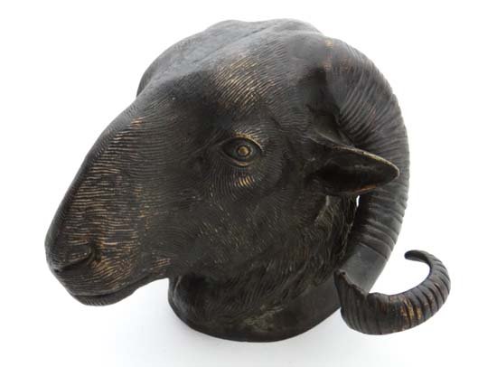 An old bronze Ram's head having coiled horns, with wall: An old bronze Ram's head having coiled horns, with wall hanging provision. 7" high