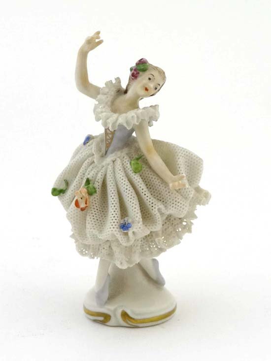 A small continental hard paste porcelain figure of a: A small continental hard paste porcelain figure of a ballerina in stood upon a base, marked under. 4" tall. £20 - 30