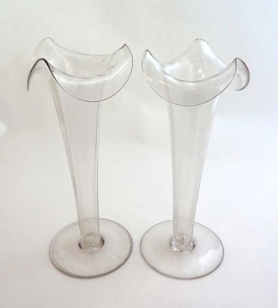 A pair of 19thC clear glass pedestal epergnes with wavy: A pair of 19thC clear glass pedestal epergnes with wavy rim decoration 11" high £20 - 30