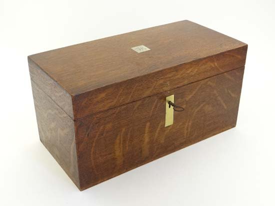 A Victorian oak tea caddy opening to reveal 2 tin lined: A Victorian oak tea caddy opening to reveal 2 tin lined sections and glass bowl 11 3/4" wide £50 - 80