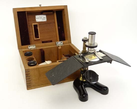 W Watson & Sons : a mahogany cased reflecting monocular: W Watson & Sons : a mahogany cased reflecting monocular Field microscope with four lenses, lacquered brass and ebonised foot, sun screens etc. the box 7 3/4" wide. £40 - 60