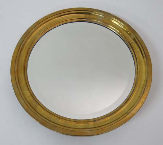 A c.1930 circular brass bevelled wall mirror 17" high: A c.1930 circular brass bevelled wall mirror 17" high £60 - 80