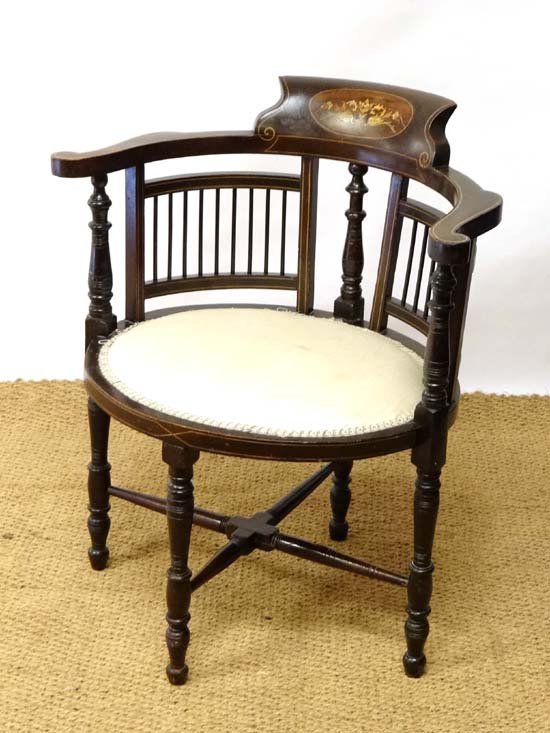 A Late Victorian American walnut open arm chair with: A Late Victorian American walnut open arm chair with oval seat and penwork, ivorine, satinwood etc inlay. 29 1/2" nigh £60 - 90