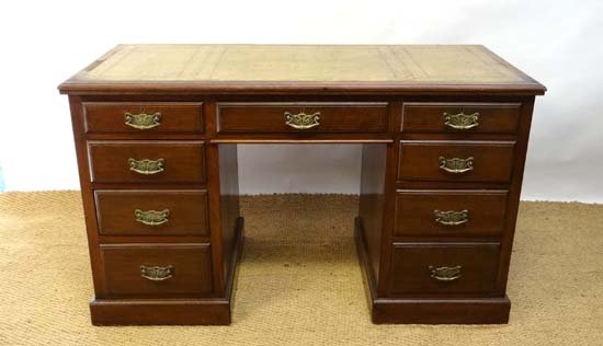 A late 19thC pedestal desk with gold tooled 3-sectional: A late 19thC pedestal desk with gold tooled 3-sectional leather top 51" wide x 22 1/2" deep £100 - 150