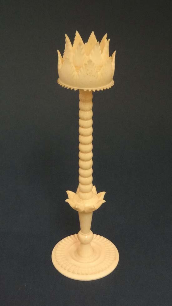 An Oriental carved bone lotus flower formed puzzle ball: An Oriental carved bone lotus flower formed puzzle ball stand 6 5/8" high £15 - 25