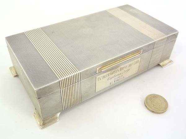 A HM silver table top cigarette box with engine turned: A HM silver table top cigarette box with engine turned decoration, hinged lid and wood lined interior Birmingham 1963 maker H Bros. and bears inscription Lytham Green Drive Golf Club Captains Prize 19