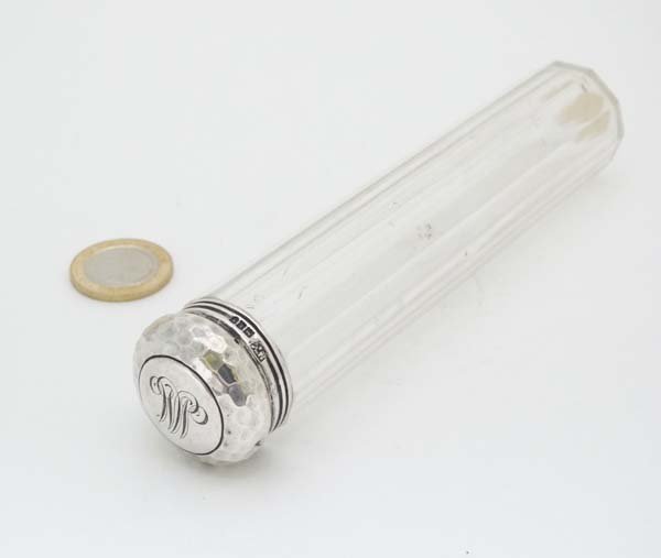 A cut glass cylindrical dressing table bottle with HM: A cut glass cylindrical dressing table bottle with HM silver top with plannished decoration London 1904 Mappin & Webb Ltd Please Note - Prospective purchasers must satisfy themselves as to the conditi