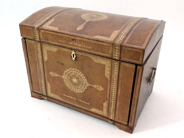 An unusual semi-domed gold tooled beige leather covered: An unusual semi-domed gold tooled beige leather covered car drinks decanter box, opening to reveal a section with fall down front 5 bottle sections and 2 glasses / food sections. 21 x 16" high