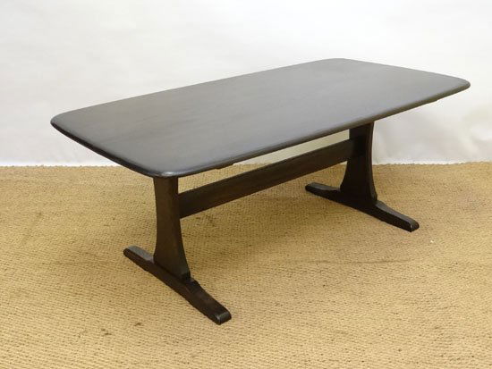 Vintage Retro : Ercol , a dark finish coffee table with: Vintage Retro : Ercol , a dark finish coffee table with two trestle legs united by a single stretcher, 48 3/4" (124cm) long x 27 1/2" (70cm) wide x 20 1/8" (52cm) high