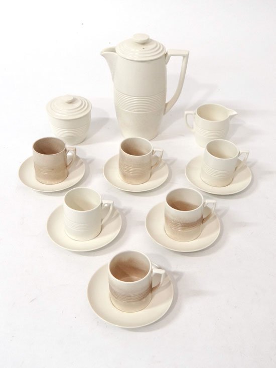 A Wedgwood Keith Murray coffee set in Moonstone,: A Wedgwood Keith Murray coffee set in Moonstone, moulded with ribbed detail and comprising coffee pot and cover, covered sugar, jug and 6 tapered cups and saucers. Printed marks to base. (15 items)