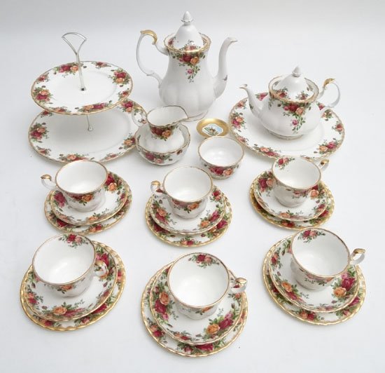 A Royal Albert Old Country Roses pattern tea service to: A Royal Albert Old Country Roses pattern tea service to include six cups , saucers and side plates, a cakestand (with additional tier) , a teapot , a coffee pot , two sugar bowls , a spoon rest and a 