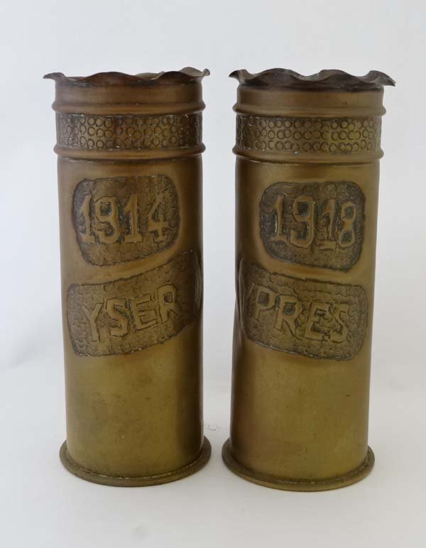 Trenchart : A pair of WW1 German 77mm Artillery Shell: Trenchart : A pair of WW1 German 77mm Artillery Shell cases, decorated ' 1914 Yser ' and ' 1918 Ypres ', the primer rims marked Patronenfabrik Karlsruhe 1907 and Haniel Luege 1918 respectively. £40 -