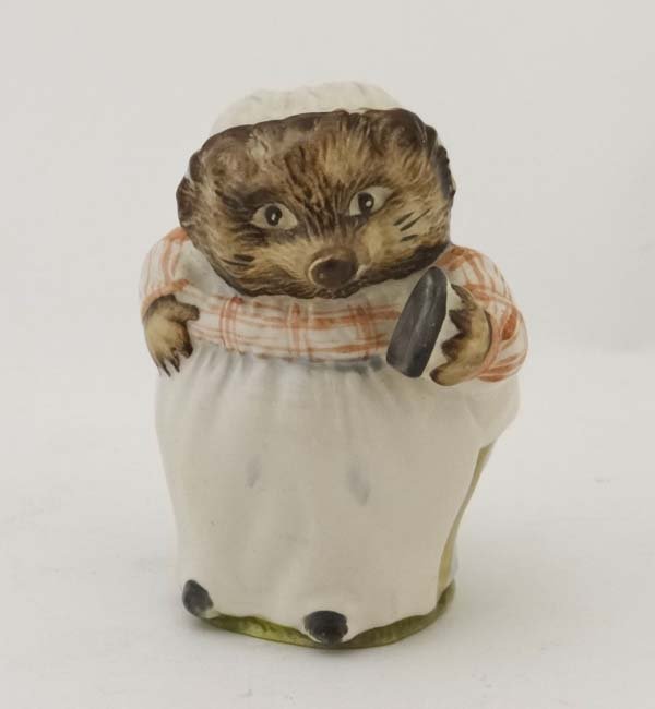 Beswick : A Beatrix Potter Mrs Tiggy Winkle labelled: Beswick : A Beatrix Potter Mrs Tiggy Winkle labelled under in brown and dated 1948, 3 1/8" high £20 - 30