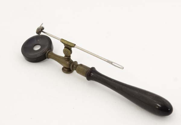 A 19thC Entomologists field microscope with turned: A 19thC Entomologists field microscope with turned horn handle, brass shaft and horn surround to lens 4 1/3" long £50 - 70
