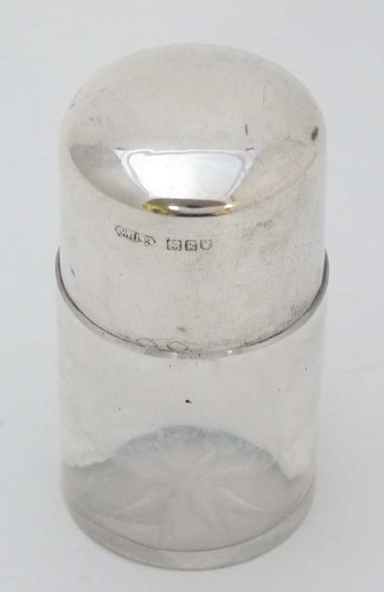 A glass salts bottle and stopper with HM silver lid: A glass salts bottle and stopper with HM silver lid bearing hallmarks for London 1905 William Harrison Walter 3" high £15 - 25
