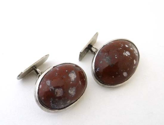 A pair of white metal cufflinks set with large agate: A pair of white metal cufflinks set with large agate cabachon £30 - 40