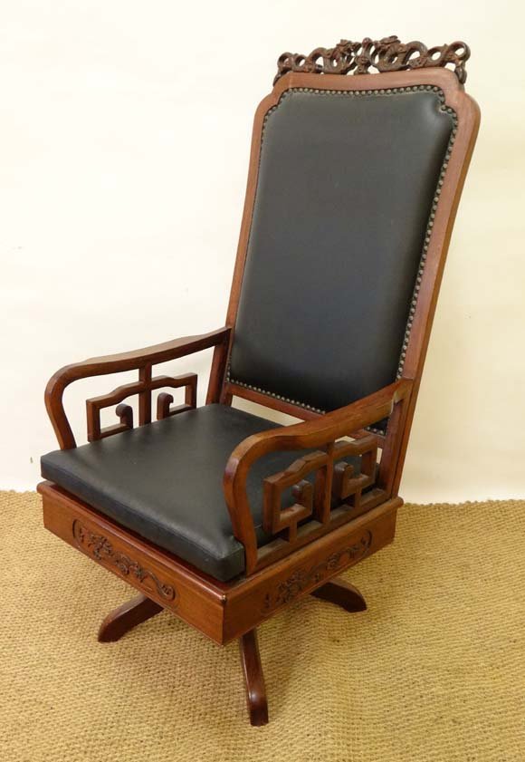 A mid - late 20thC Chinese hardwood ( swivel and tilt ): A mid - late 20thC Chinese hardwood ( swivel and tilt ) office chair with high back surmounted by a cresting of scrolling dragons 50" high Please Note - we do not make reference to the condition of lo