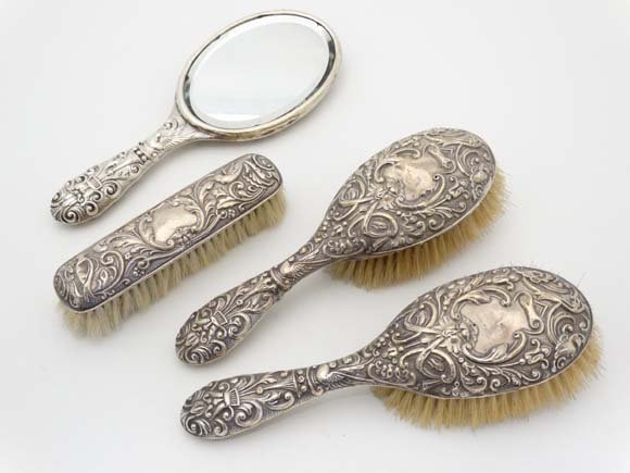 A 4 piece silver dressing table set comprising 3: A 4 piece silver dressing table set comprising 3 brushes and a hand mirror . Hallmarked Birmingham 1905 maker A & J Zimmerman Ltd. Please Note - we do not make reference to the condition of lots withi