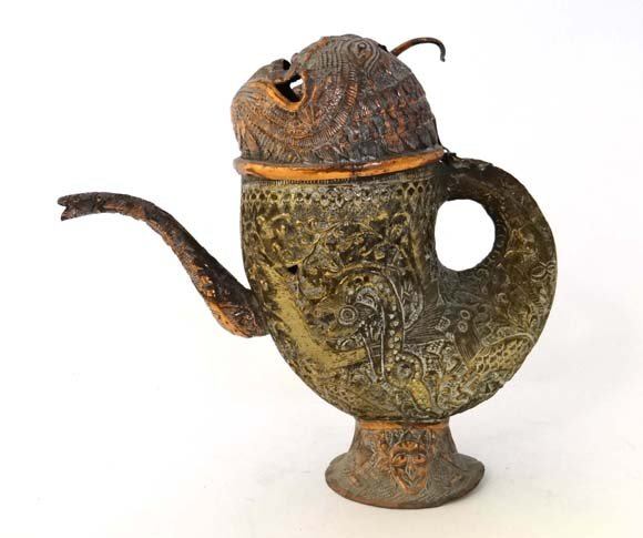 A 19thC Indian parcel gilt copper teapot with pierced: A 19thC Indian parcel gilt copper teapot with pierced tiger head lid and embossed with animals and floral designs. Approx 9 1/2" high Please Note - we do not make reference to the condition of lots wi