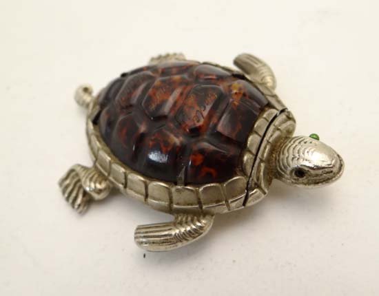 A charming novelty vesta formed as a tortoise with: A charming novelty vesta formed as a tortoise with silver plate body head and limbs with celluloid formed shell Hinging open at neck and with striker to body. Engraved Uncle Jack from Hubert 2 1/4" lo