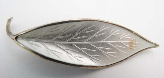 Norwegian silver jewellery : A Silver brooch by David: Norwegian silver jewellery : A Silver brooch by David Andersen of Norway formed as a stylised leaf with white guilloché enamel decoration. Marked to reverse D-A Norway Sterling etc 2 1/2" long Please