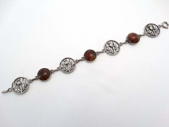 John Hart : A Scottish silver bracelet set with 3 agate: John Hart : A Scottish silver bracelet set with 3 agate cabachon and 4 roundels with thistle decoration. Marked to reverse ' Silver " Iona " and HJ monogram for John Hart Please Note - we do not make