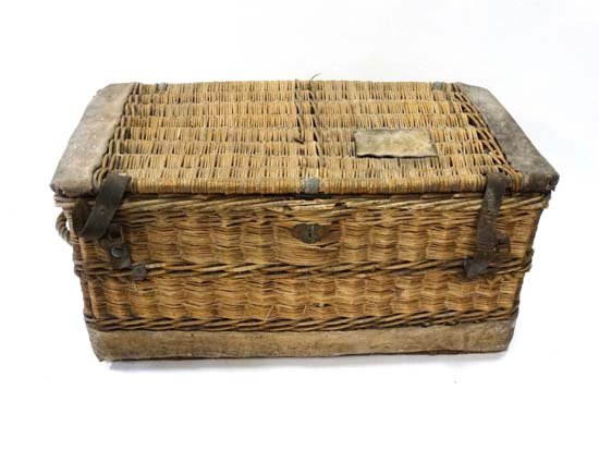 A c.190 wicker laundry basket with leather straps and: A c.190 wicker laundry basket with leather straps and leather ends, brass lock and rope handles. 36" wide x 18" high