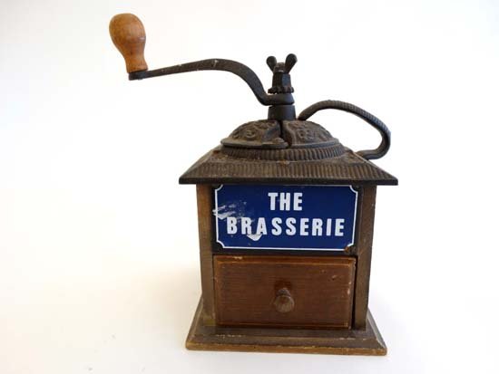 A French cast iron and wooden coffee grinder marked: A French cast iron and wooden coffee grinder marked with enamel plaque ; 'The Brassiere ' Approx. 10" high
