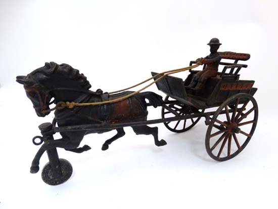 Toy - American Cast iron '' Horse drawn dog cart '': Toy - American Cast iron '' Horse drawn dog cart '' with driver in a bowler hat. In the style of Pratt and Letchworth. Height 5 1/2''