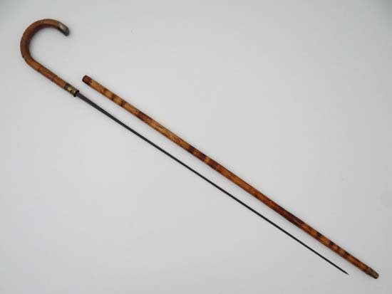 Collectors Sword Stick / Cane : A Crook handled walking: Collectors Sword Stick / Cane : A Crook handled walking cane , the handle withdrawing to reveal a ' Soligen ' 2-4 sided Blade, with brass collar and ferule with a Hall Marked silver end. 37" long Plea