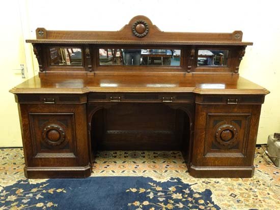 Scottish Arts & Crafts : John Taylor & Son Edinburgh -: Scottish Arts & Crafts : John Taylor & Son Edinburgh - A late 19thC oak inverted break front sideboard with low triple mirrored back, shelf and carving. Signed 94" wide x 57 1/4" high Please Note - we