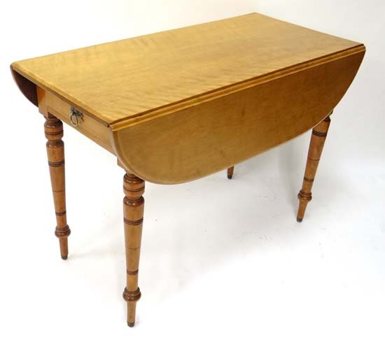 A late Victorian satinwood oval Pembroke table with: A late Victorian satinwood oval Pembroke table with drawer to one end 41 3/4" long x 20" closed Please Note - we do not make reference to the condition of lots within catalogue descriptions. We are ho