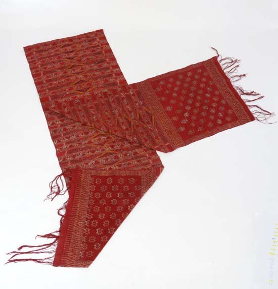 A silk and metal wrapped thread sash: A silk and metal wrapped thread sash with weft ikat bands , Bali , mid-20th century. 183 x 105 cm (73 x 42 inches).Made for Thailand (or Malaysia). 229 x 36 cm (90 x 14 inches)Please Note - we do not 