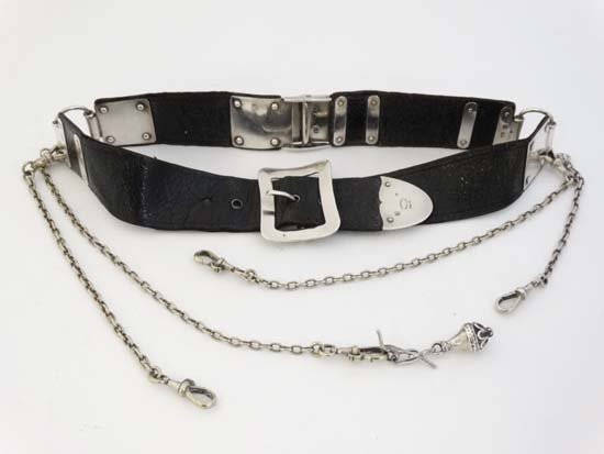 A Victorian house keepers black leather chatelaine belt: A Victorian house keepers black leather chatelaine belt with hallmarked silver buckle and mounts and sections for hanging chatelaine attachments. Extensively hallmarked London 1876 maker Wright & Davi