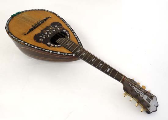 Musical Instruments : A late 19th C Italian Mandolin ,: Musical Instruments : A late 19th C Italian Mandolin , retailed by L & W Montagu , Piccadilly . The bowlback body with panelled decorative veneers and trade label within . The maple top , ebony bridge