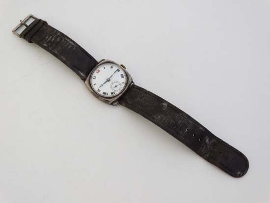 Gents Silver Watch : an early imported silver Swiss: Gents Silver Watch : an early imported silver Swiss wristwatch with a circular white enamel dial with red 12 and inset seconds dial at 6, Roman Numerals , the case numbered 127786 , bears import marks