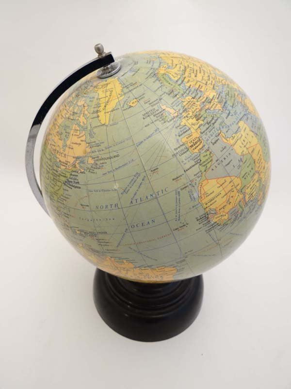 Globe on stand : an 8 inch globe by Geographia of: Globe on stand : an 8 inch globe by Geographia of London named “The Planet” with chromed North - South meridan ring and black Bakelite circular stepped base, circa 1930, labelled . Please Note - w