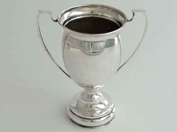 A silver pedestal 2-handled trophy cup. Maker Charles: A silver pedestal 2-handled trophy cup. Maker Charles Boyton & Son Ltd , London early 20thC 5 1/2" high (84g) Please Note - we do not make reference to the condition of lots within catalogue descripti