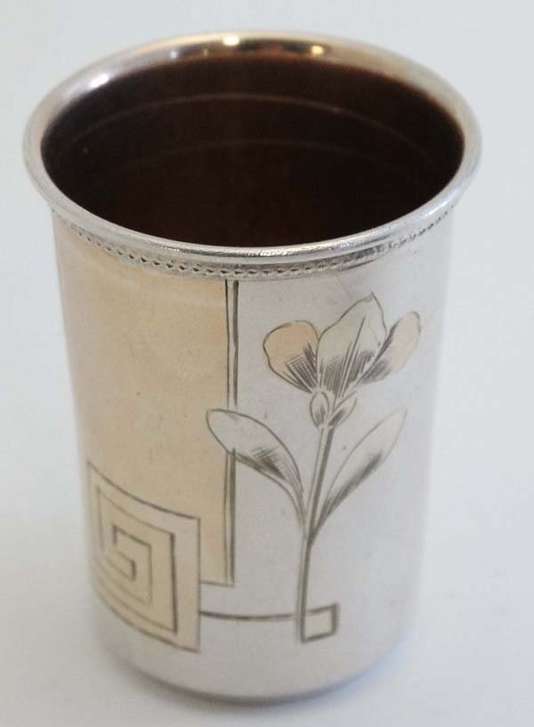 A Russian silver vodka cup with engraved floral: A Russian silver vodka cup with engraved floral decoration and gilded interior . Marked under, Moscow early 20thC ( second Kokoshnik Mark ) 2" high (26g) Please Note - we do not make reference to the 