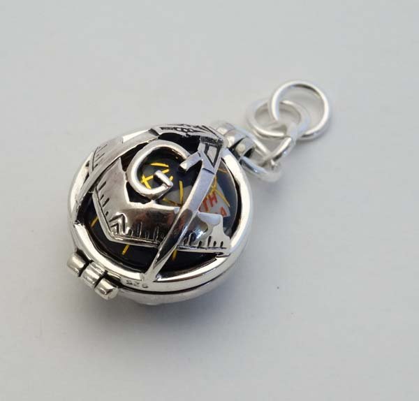 A 925 silver pendant, 2-sectional outer with Masonic: A 925 silver pendant, 2-sectional outer with Masonic emblems with central sphere of globe form. 1" high Please Note - we do not make reference to the condition of lots within catalogue descriptions. W