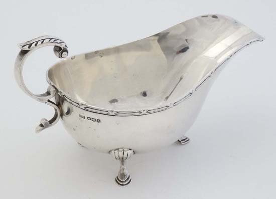 A silver sauce boat. Hallmarked Sheffield 11925 maker: A silver sauce boat. Hallmarked Sheffield 11925 maker Walker & Hall. 6 1/2" long (114g)