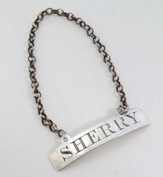 A Geo III silver wine / decanter label ' Sherry ': A Geo III silver wine / decanter label ' Sherry ' hallmarked London 1797 maker John Hutson 1 7/8" wide (6g)
